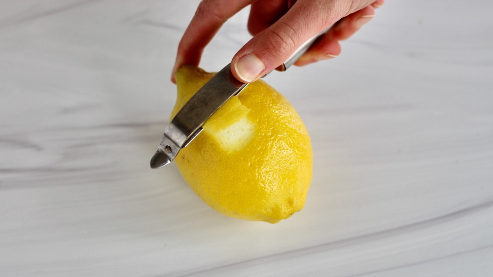 Снятие лимонной цедры с помощью овощечистки